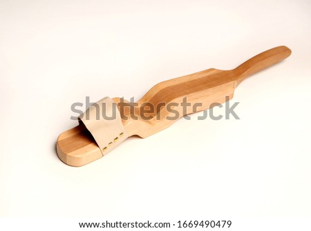 ballet trainer for a beautiful foot made of wood with dense skin on a white background