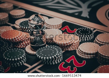 Casino concept background. Poker chips on the table. A gaming table in a luxury casino. Casino symbols composition. Roulette wheel, poker chips, dice, cards. Recreation and entertainment concept.

