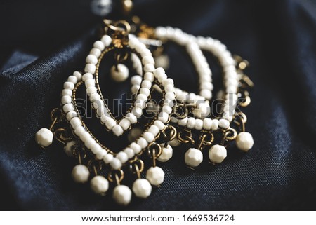 Close-up of a couple ethnic style earrings with white beads