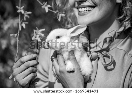Happy easter. Egg hunt. Rabbit on close up woman mouth background. Alice in Wonderland