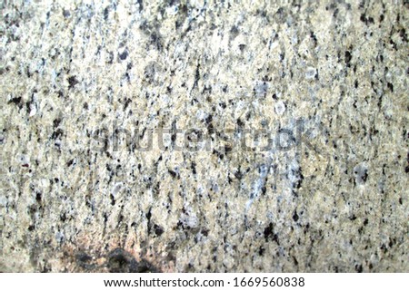 Spotty texture of a solid natural mineral. Light granite with different overlays. Beautiful modern background with modern material. Neutral abstract background for design. Place for text and picture.