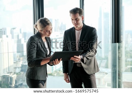 Two businessman and businesswoman couple meeting in co working space at sky lounge Royalty-Free Stock Photo #1669575745