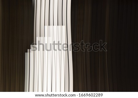 Abstract black and white vertical stripes. Bright lights at night.