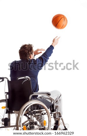 A disabled man on a wheelchair throwing a basketball