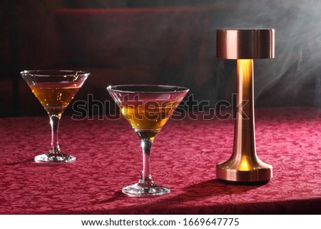Martini in a transparent glass near the lamp
