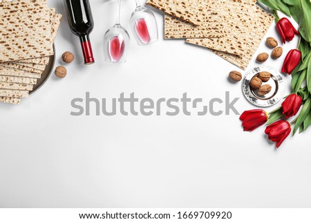 Flat lay composition with matzos on white background, space for text. Passover (Pesach) celebration Royalty-Free Stock Photo #1669709920