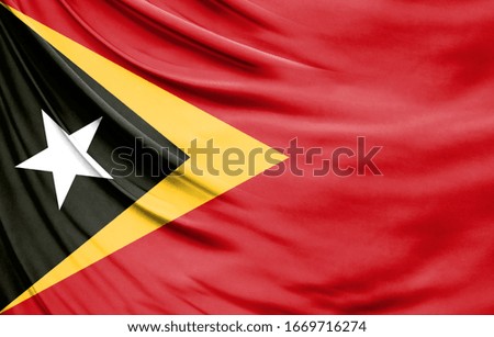 Realistic flag of East Timor on the wavy surface of fabric