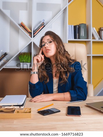 Successful business woman is sitting at the table