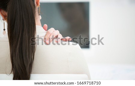Japanese business woman holding shoulder Royalty-Free Stock Photo #1669718710