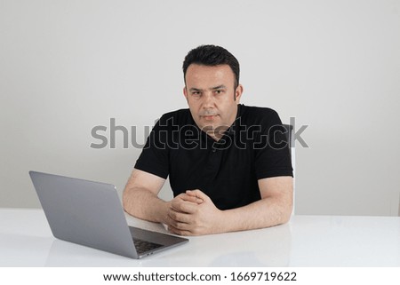Business man at office, dressed in black t-shirt                    