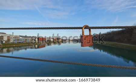 Metal padlocks of love hanging on fence in Maribor