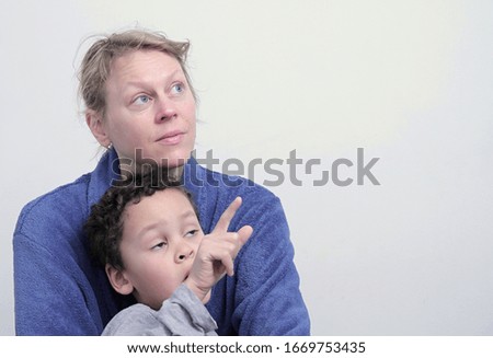 mother and child looking up with white background stock photo 