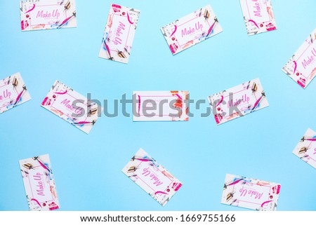 Many business cards of makeup artist on color background