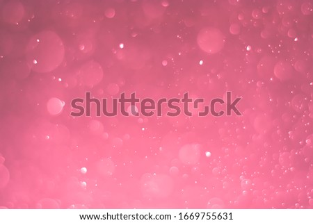 Abstract bokeh lights with light red background
