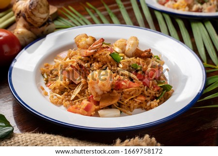 fried rice in plate on wooden table in restaurant
