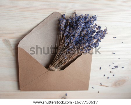 Bright lavander on wooden background with letter