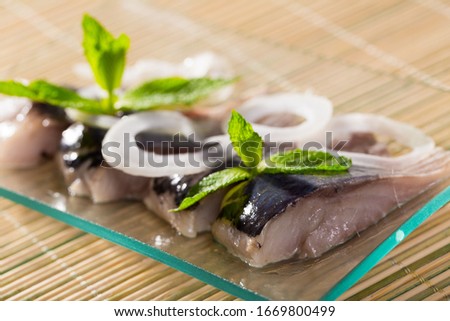 Photography of plate with salted herring with onions in restaurante.