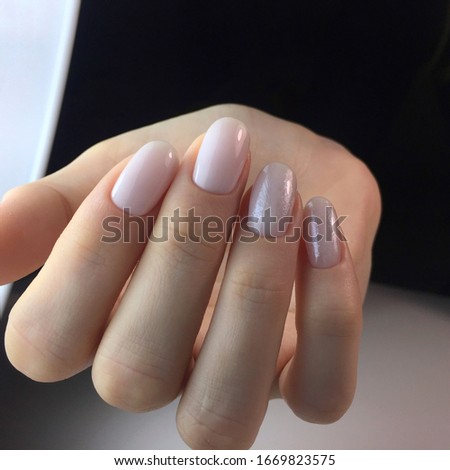 Hands of a woman with pink manicure on nails.Manicure beauty salon concept. Empty place for text or logo.