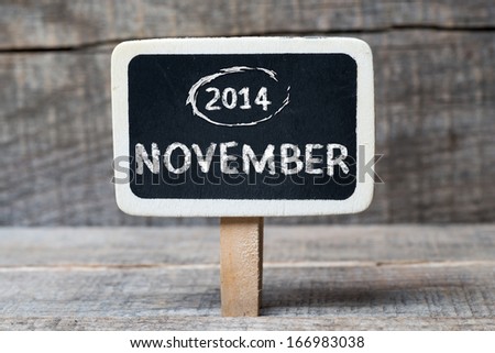 November 2014 Small wooden framed blackboard with wooden background