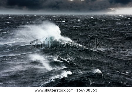 Waves Breaking and Spraying at High Seas and Strong Winds Royalty-Free Stock Photo #166988363