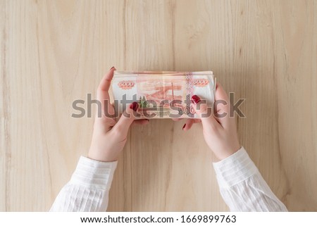 woman hold banknote five thousand rubles in hand and count it. Money exchange. Bank operation. Finance services. Financial market. Foreign currency exchange point. Concept. Flat lay