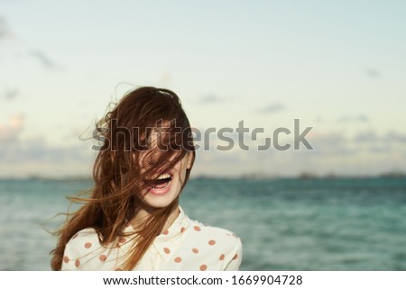 young woman in a beautiful summer dress on the sandy beach