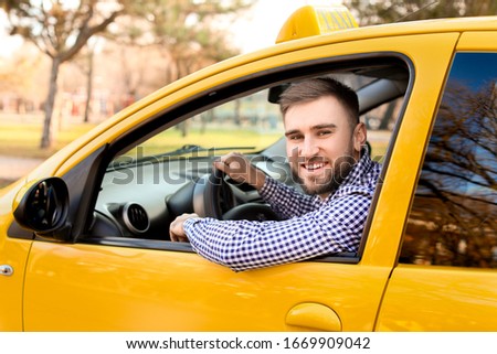 Portrait of handsome driver in taxi car Royalty-Free Stock Photo #1669909042