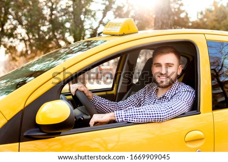 Portrait of handsome driver in taxi car Royalty-Free Stock Photo #1669909045