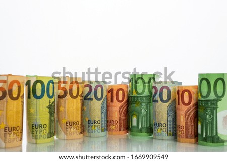There are euro banknotes against a white background