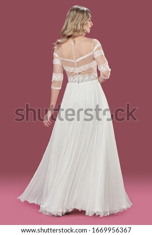 Beautiful bride posing in wedding dress in  photo studio isolated 