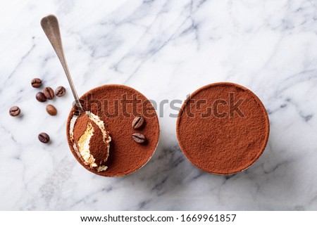 Tiramisu dessert in glasses. Marble background. Copy space. Top view. Royalty-Free Stock Photo #1669961857