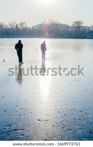 People skating on a frozen lake