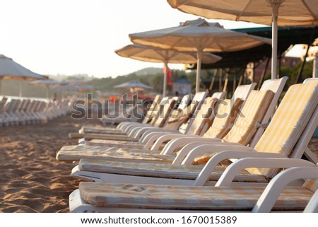 free sun loungers and sunbeds on the beach. bright soft photo