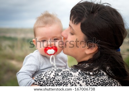 Mother and her baby in a portrait outdoors