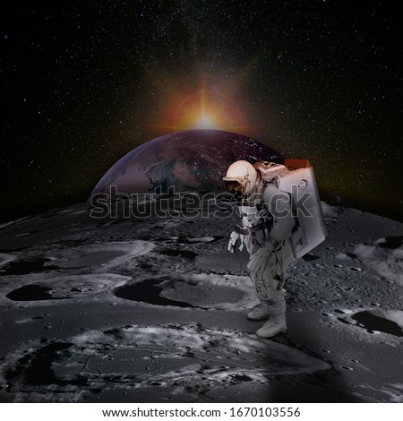 Astronaut on moon surface with space background. Planet Earth rises above the surface of the Moon, dotted with craters, and the sunlight behind.  Elements of this image furnished by NASA. Royalty-Free Stock Photo #1670103556