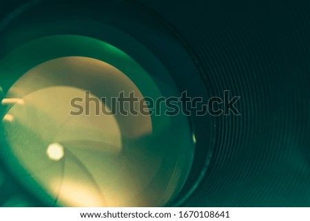 Beautiful camera lens with green  light of glass. Background pattern for design.	