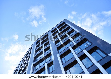 Modern office building facade abstract fragment, shiny windows in steel structure