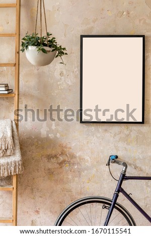 Modern composition of living room interior with black mock up poster frame, wooden ladder, plant, hipster bike and personal accessories in wabi sabi concept. 