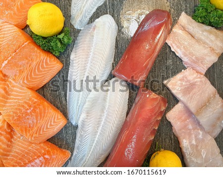 Fish market/Fresh fish on ice. Salmon Fish. Fresh seafood on ice. Octopus and Red fish ready to buy. Seafood market/Seafood variety. Show-window of seafood in the sea market
. Picture from smartphone  Royalty-Free Stock Photo #1670115619
