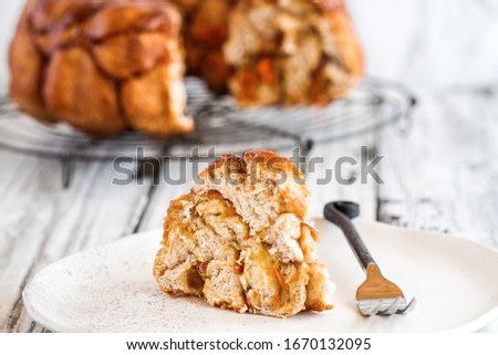 Easter dessert of Pull Apart Carrot Cake Monkey Bread. A yeast bundt cake made with cinnamon, carrots, nuts and a brown sugar glaze. Selective focus with blurred foreground and background.