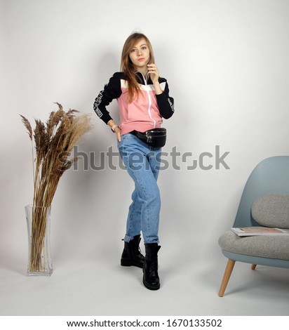                         Beautiful young blonde girl posing on camera.Isolated studio portrait       