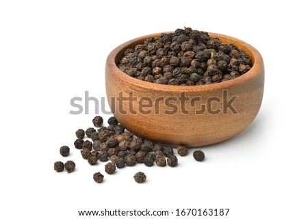 Black peppercorns (Black pepper) in wooden bowl isolated on white background. Royalty-Free Stock Photo #1670163187