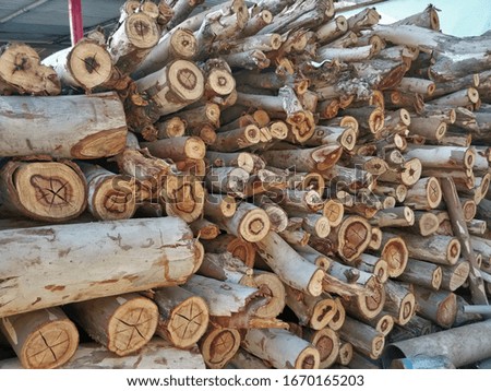 Chopped firewood logs stacked up on top of each other in a pile