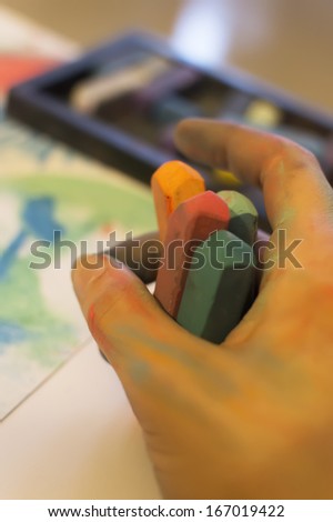 young women hand draw with colored chalk