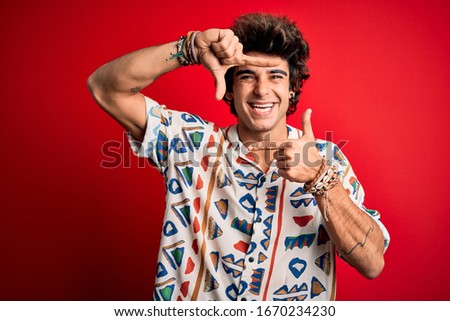 Young handsome man on vacation wearing summer shirt over isolated red background smiling making frame with hands and fingers with happy face. Creativity and photography concept.