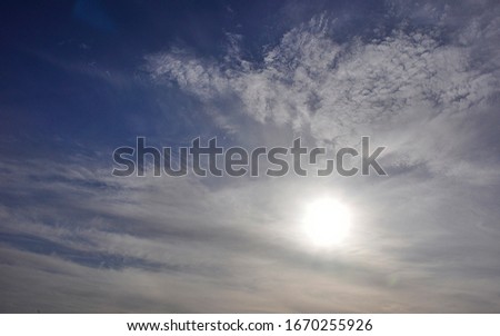 The sun in the light cirrostratus clouds. Weather change. Royalty-Free Stock Photo #1670255926