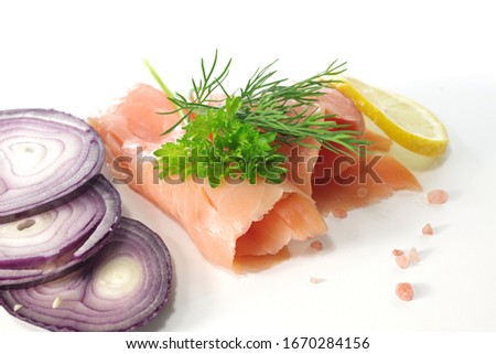 slices of smoked salmon with dill on white background