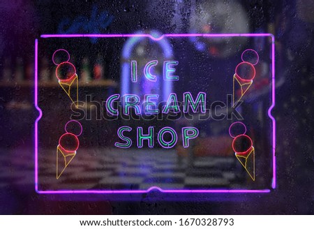 Neon Ice Cream Shop Sign in Rainy Window