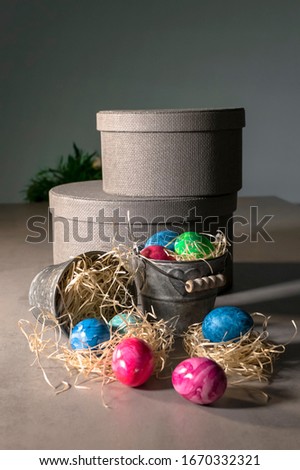 Painted easter eggs with buckets and round boxes