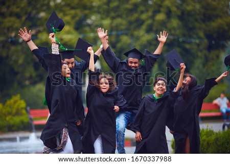 group of happy indian students celebrating the college graduation, passing the final university exam Royalty-Free Stock Photo #1670337988